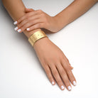 1865 - 14kt yellow gold matte hammered cuff bracelet with torched shiny edges, enhanced with .22ctw of scattered bezel set diamonds