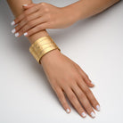 7367 - 14kt yellow gold hammered cuff bracelet, with three-row of shiny diamond wavy stripes