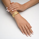 7518 - 14kt yellow gold hammered finish and shiny edge cuff bracelet, enhanced with scattered bezel set diamonds and multicolor sapphires